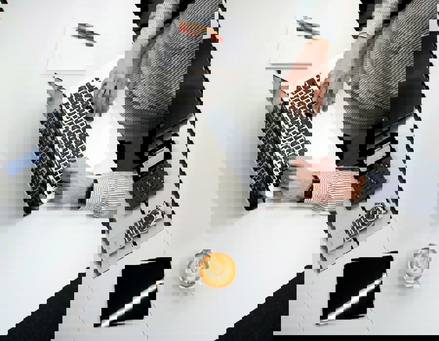 Person Using Laptop On White Wooden Table 1E1db071dca7dd4b3b9aec68d8ed3aad